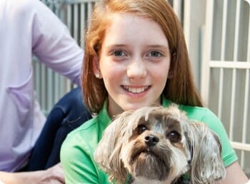 teenage girl holding a dog for a non profit fundraiser