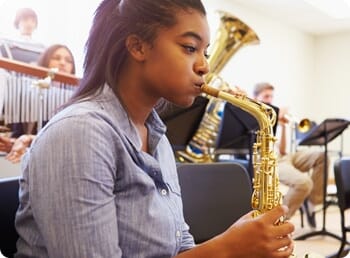 girl playing the trumpet in a band